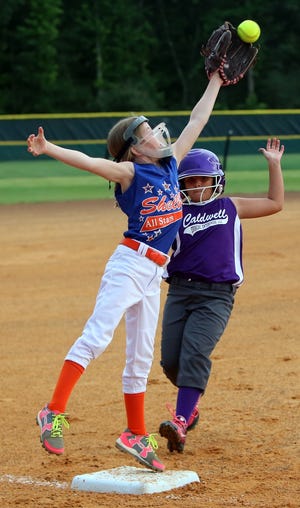 Shelby´s Kaylee Greene leaps for the ball to tag out Caldwell County runner Taylor Hall during their 8-under fastpitch softball tournament game at Shelby City Park in 2016. [Brittany Randolph/The Star]