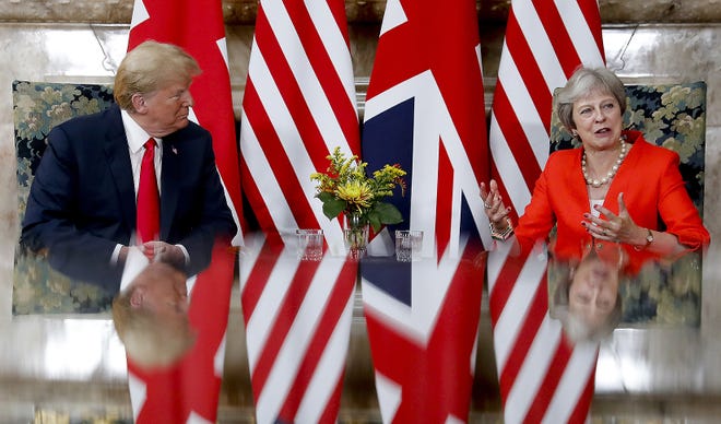 U.S. President Donald Trump, left, with British Prime Minister Theresa May, right, during their meeting at Chequers, in Buckinghamshire, England, Friday. [PABLO MARTINEZ MONSIVAIS/ASSOCIATED PRESS]