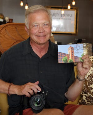 Photographer Tom Hauer poses with one of his postcards which are on sale at Hive Design on West Main Avenue in Gastonia Tuesday morning, July 10, 2018. [Mike Hensdill/The Gaston Gazette]