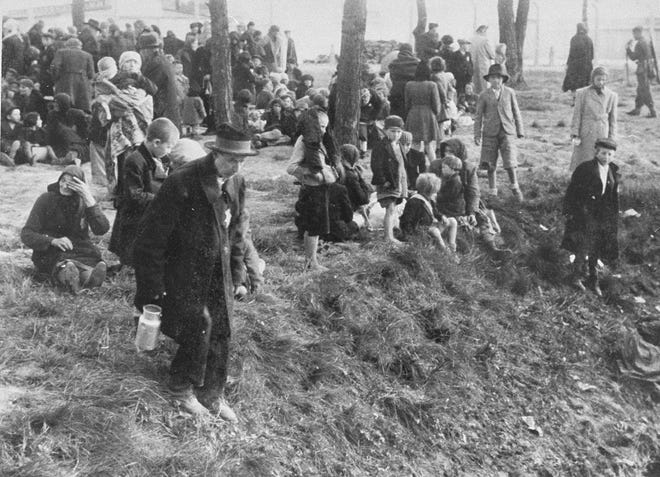 FILE PHOTO: Jews from Subcarpathian Rus in Ukraine who have been selected for death at Auschwitz-Birkenau wait in a clearing near a grove of trees before being led to the gas chambers in May 1944.
