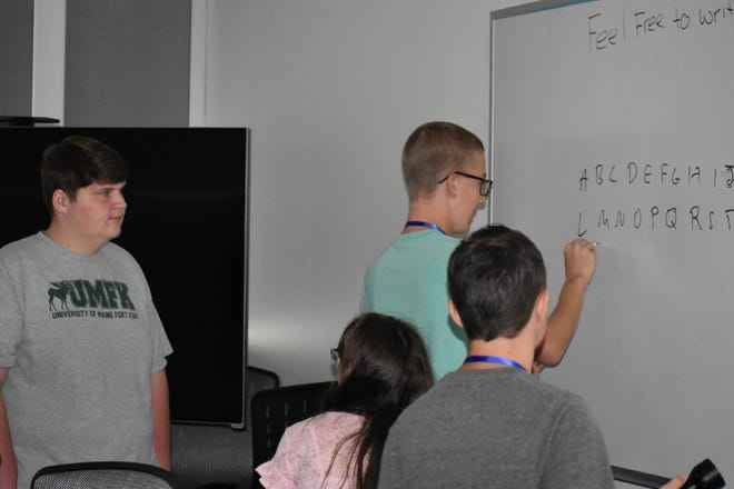 Students of Santa Rosa and Escambia County solve clues to "escape" the Cryptography Room Escampe Challange at the GenCyber camp at UWF. [Kevin Boyer | Press Gazette]