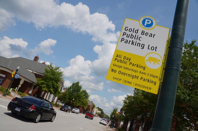 A new parking plan for downtown New Bern went into effect July 9. The plan, which features enforced two-hour on-street parking, has drawn a mix of reactions from local business owners and shoppers. [TODD WETHERINGTON / SUN JOURNAL STAFF]