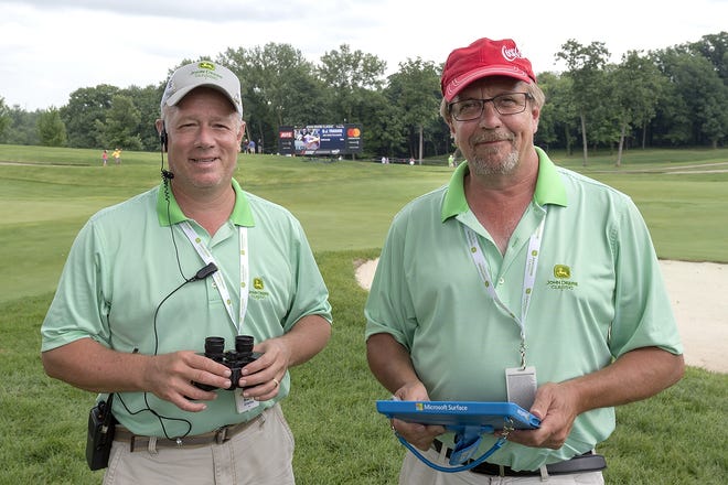 Galesburg natives Brad Hix, left, and Dave Hix, right, have been volunteering as shot trackers at the John Deere Classic for seven years. [MITCH COLGAN/The Register-Mail]