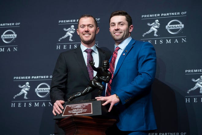 FILE - This Dec. 9, 2017 file photo shows Oklahoma head football coach Lincoln Riley, left, standing with Oklahoma quarterback Baker Mayfield, winner of the Heisman Trophy, during a news conference in New York. Oklahoma won another Big 12 title and made it to the College Football Playoff again in its first season without coach Bob Stoops on the sidelines. The Sooners, who have won the last three Big 12 titles with Mayfield, will now be trying to do it again without the Heisman Trophy winner under center. Even with Mayfield now in the NFL, 11-time Big 12 champion Oklahoma goes into the league’s football media days as the preseason pick to win another title ahead of West Virginia. Riley, Oklahoma’s offensive coordinator for two years before succeeding Stoops last summer, will be the last of the five coaches who will take the main podium Monday for the first half of media days at the Dallas Cowboys’ headquarters in suburban Frisco north of downtown Dallas. (AP Photo/Craig Ruttle)