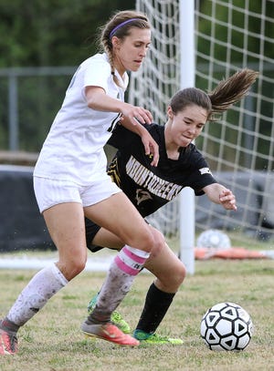 Forestview's Reagan Sandford and Kings Mountain's Rece Guy battle for the ball during their match at Forestview High School last spring. [JOHN CLARK/THE GASTON GAZETTE]