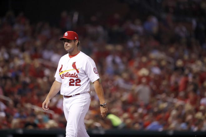 St. Louis Cardinals manager Mike Matheny walks out to the mound to make a pitching change during the sixth inning Friday. He won't make that walk again after the Cardinals fired Matheny following the 8-2 loss to the Cincinnati Reds. [Jeff Roberson/The Associated Press]