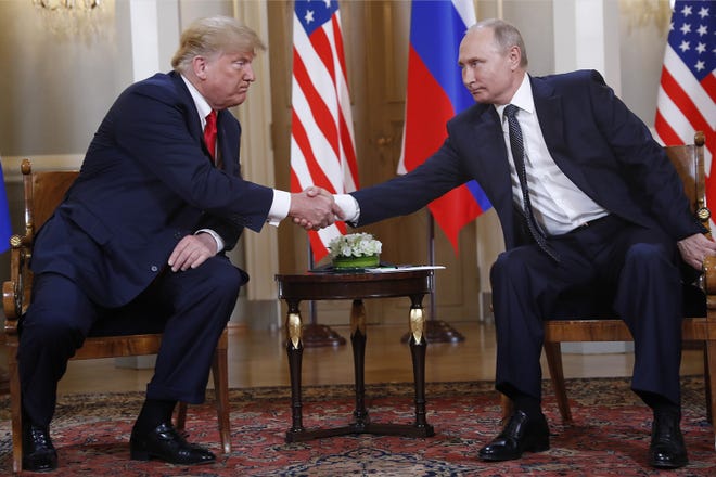 U.S. President Donald Trump, left, and Russian President Vladimir Putin shake hand at the beginning of a meeting at the Presidential Palace in Helsinki, Finland, Monday. [AP Photo/Pablo Martinez Monsivais]