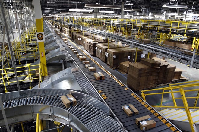 In this Aug. 3, 2017photo, packages ride on a conveyor system at an Amazon fulfillment center in Baltimore. Amazon's Prime Day starts July 16 and will be six hours longer than last year's and will launch new products. [AP Photo/Patrick Semansky, File]