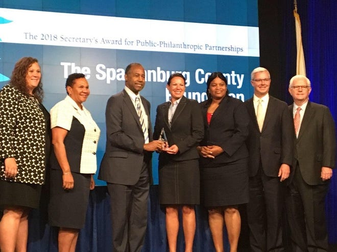 Representatives from The Spartanburg County Foundation and the Northside Initiative accepted the award in Washington D.C. on Monday. Pictured (left-right), Tara Weese, Terril Bates, Dr. Ben Carson, Tammie Hoy Hawkins, Wanda Cheeks-Holmes, Troy Hanna, Gene Cochrane. [PROVIDED]