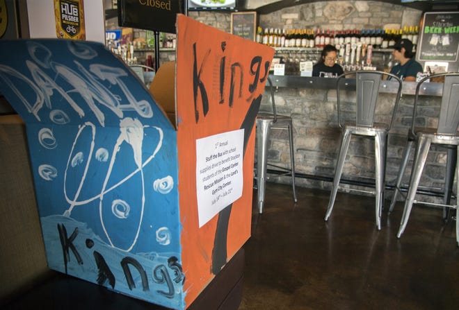 A donation box sits inside the entrance to the Squeeze Burger restaurant in Lincoln Center in Stockton as a part of the Stockton Kings' "Stuff the Bus" campaign to benefit students of the Gospel Rescue Mission and the Lord's Gym Center. [CLIFFORD OTO/THE RECORD]