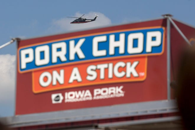 The helicopter of Donald Trump flies over a pork chop on a stick stand at the Iowa State Fair in Des Moines, Iowa, on Aug. 15, 2015. MUST CREDIT: Bloomberg photo by Andrew Harrer.