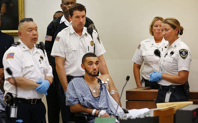 Suspect Emanuel Lopes is arraigned Tuesday in Quincy District Court on two counts of murder in the shooting deaths of Weymouth police officer Michael Chesna and resident Vera Adams. [Greg Derr/The Patriot Ledger]