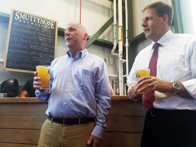 Gov. Chris Sununu, right, shares a toast with Smuttynose Brewing Company CEO Richard Lindsay Tuesday, helping celebrate the new ownership's first 100 days. [Max Sullivan/Seacoastonline]