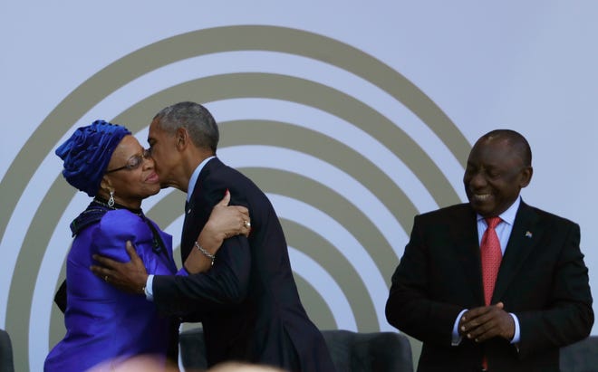 Former U.S. President Barack Obama, center, greets the Nelson Mandela's widow, Graca Machel with President Cyril Ramaphosa as he arrives at the Wanderers Stadium on Tuesday in Johannesburg, South Africa to deliver the 16th annual Nelson Mandela Lecture. Obama urged Africans and people around the world to respect human rights and equal opportunity in his speech to mark the late Nelson Mandela's 100th birthday. [Themba Hadebe/The Associated Press]