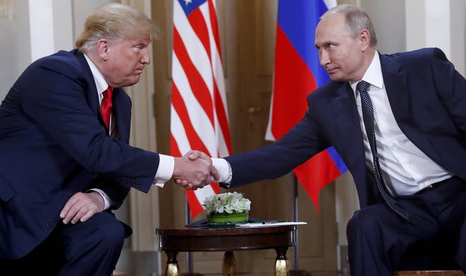 U.S. President Donald Trump, left, and Russian President Vladimir Putin, right, shake hand at the beginning of a meeting at the Presidential Palace in Helsinki, Finland, Monday, July 16, 2018. (AP Photo/Pablo Martinez Monsivais)