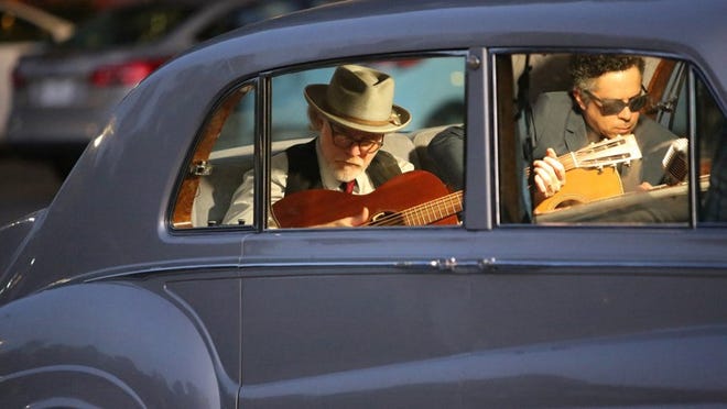 Musicians Mike Coykendall, left, and M. Ward play in the back seat of a Rolls-Royce once owned by Elvis Presley. “The King” features a number of impromptu musical performances. Contributed by David Kuhn, Oscilloscope Laboratories
