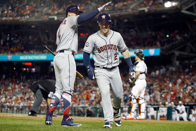 Houston Astros George Springer (4) congratulates Houston Astros Alex Bregman (2) on Bregman's solo home run during the tenth inning at the Major League Baseball All-star Game, Tuesday, July 17, 2018 in Washington. (AP Photo/Patrick Semansky)