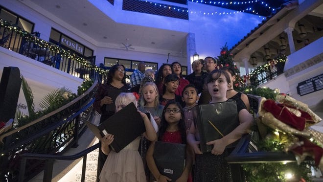 Members of the Palm Beach Children’s Chorus sing “Silent Night” during the inaugural tree lighting ceremony at The Esplanade in November 2017. (Andres Leiva / Daily News)