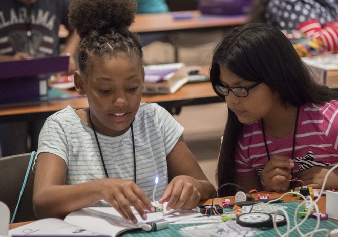 Ten-year-old Kaylonie Vickers from Marshall Elementary School, left, and 11-year-old Cynthia Caldera from McKinley Elementary work together to build a robotic arm on Wednesday at San Joaquin Delta College's Verizon Innovative Learning summer program. Women continue to be underrepresented in STEM careers, and the program hopes to introduce more girls to career options.

[CLIFFORD OTO/THE RECORD]