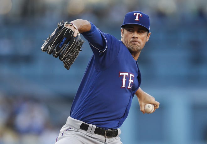 (File) Former Phillie Cole Hamels, now pitching for the Rangers, could bolster the Phils' starting staff. [JAE C. HONG/ASSOCIATED PRESS]