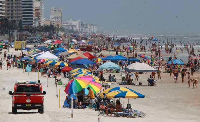 Beaches along Volusia County's coast, like in Daytona Beach Shores, were crowded Thursday. Beach Safety Ocean Rescue officials expect the sands to be packed over the weekend, but also expect surf conditions to be extremely rough. [News-Journal/Jim Tiller]
