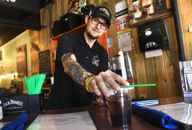 Chef Leighton Knowles serves a cup of cold CBD-infused coffee at Fresh Vibes in Rochester. 
[Deb Cram/Fosters.com]