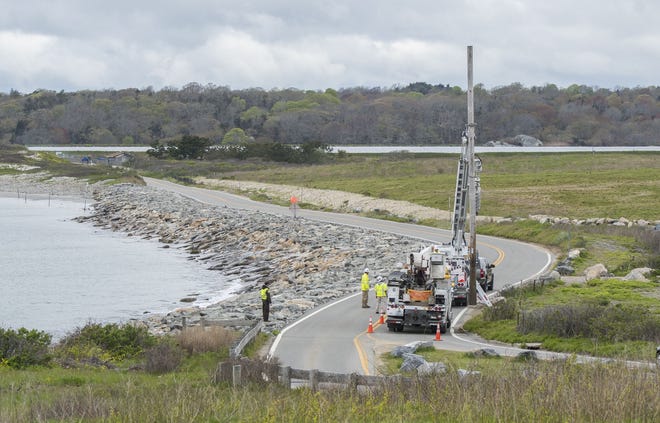 National Grid workers take down a pole on Sachuest Point Road in Middletown in May 2017. Under a proposal filed Thursday, the company would boost rates 19 percent starting Oct. 1. [DAILY NEWS FILE PHOTO]