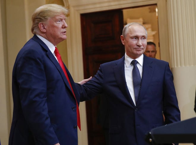 U.S. President Donald Trump, left, and Russian President Vladimir Putin, right, leave the stage together at the conclusion of their joint news conference at the Presidential Palace in Helsinki, Finland on Monday, July 16. [ PABLO MARTINEZ MONSIVAIS ]
