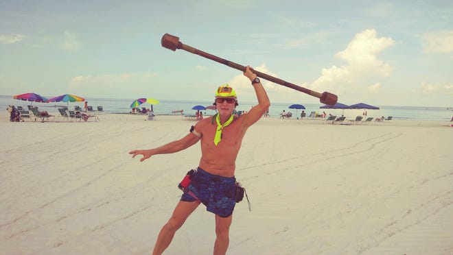 Steve Upton, 65, is an offbeat fixture on Siesta Key Beach, walking 3 miles a day while doing exercises with a 12-pound homemade stick. [Herald-Tribune staff photo / Photo Chris Anderson]