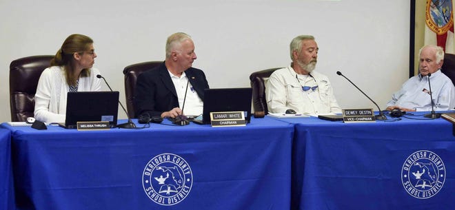 Okaloosa County School Board members (left to right), Melissa Thrush, Lamar White, Dewey Destin and Rodney Walker, listen as attorney Jeff McInnis discusses an agreement the board reached to settle a racial harassment case filed in 2016 by the parents of two black students attending Baker School.

[FILE PHOTO/DAILY NEWS]