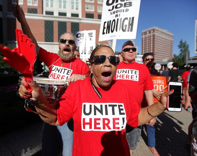 Carmen Castillo, center, walks an informational picket line outside the Omni Providence Hotel on West Exchange Street in Providence on Friday afternoon. Castillo, a Providence city councilwoman who works in housekeeping at the Omni, walked with other hotel workers represented by UNITE HERE, which is in contract negotiations with the hotel. [The Providence Journal / Glenn Osmundson]
