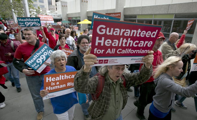 FILE - In this April 26, 2017 file photo supporters of single-payer health care march to the Capitol in Sacramento, Calif. Health care is one of the sticking points between the major gubernatorial candidates in the June primary. [AP Photo/Rich Pedroncelli, file]