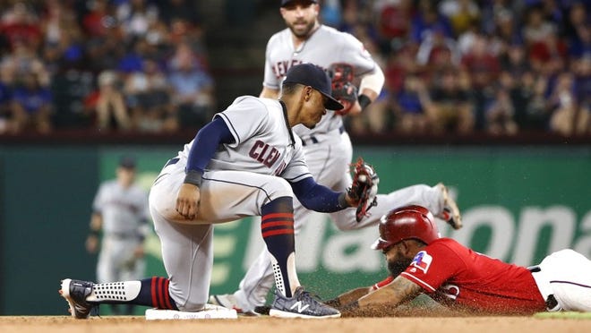 Rougned Odor of the Texas Rangers steals second base as Francisco Lindor of the Cleveland Indians is late with the tag during the fifth inning Friday night. The Indians won in 11 innings. RON JENKINS/GETTY IMAGES