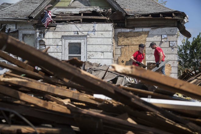 Clean up continues Saturday outside homes in Marshalltown two days after a devastating tornado blew through the city. The tornado here was among a flurry of unexpected twisters that swept through central Iowa on Thursday. [Kelsey Kremer/The Des Moines Register]