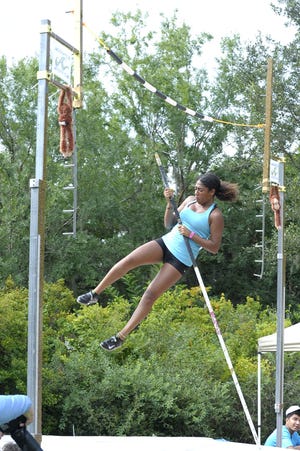 Safiyah Tobgy, 16 , of the Thin Air Vault Club in Orlando, practices at a pole vault meet Saturday at the Jacksonville Zoo and Gardens. Hosted by the Jacksonville Athletic Club, it was presented as the world's first pole vault competition inside a zoo. [Dede Smith/For the Times-Union]
