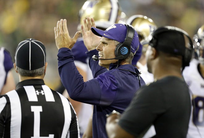 Washington head coach Chris Petersen reacts after see in a replay in which a pass was called incomplete in the end zone in the third quarter at Autzen Stadium. After reviewing the play, the catch was call good and the touchdown was confirmed. (Andy Nelson/The Register-Guard)