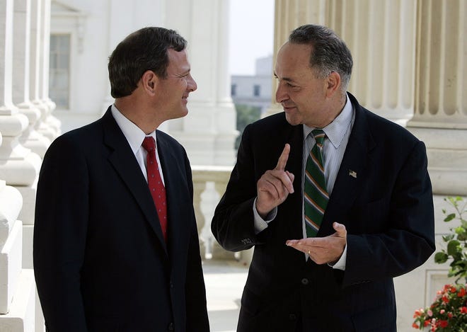 Judge John G. Roberts, President Bush's choice to fill the vacancy on the U.S. Supreme Court, meets Sen. Charles Schumer (D-NY) on Capitol Hill on July 21, 2005, in Washington. [CHUCK KENNEDY/KRT]