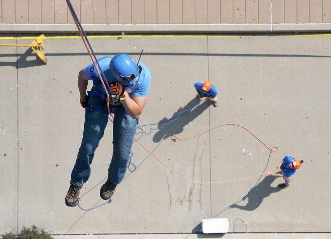Brandon Shields, left, rappels from the Bicentennial Tower In Erie during the 1017 Over the Edge fundraiser. The 2018 event is Friday. [GREG WOHLFORD FILE PHOTO/ERIE TIMES-NEWS]