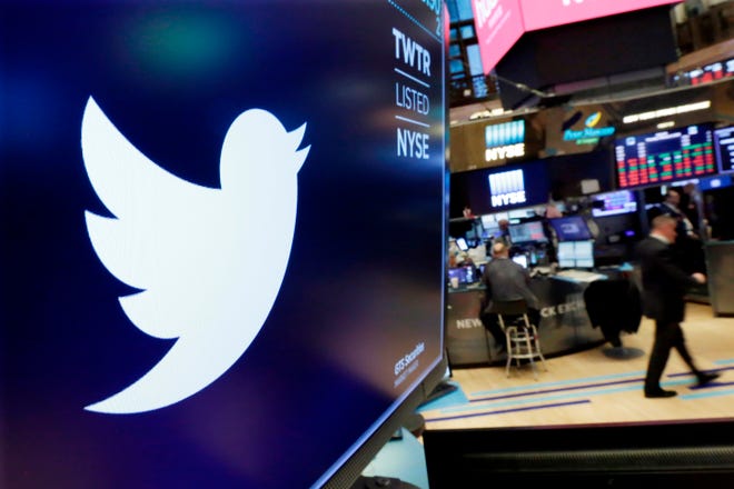 In this Feb. 8, 2018, file photo, the logo for Twitter is displayed above a trading post on the floor of the New York Stock Exchange. Calls to ban Donald Trump from Twitter are as old as his presidency. But it’s not going to happen, at least not while he’s president. Twitter’s view is that keeping up political figures’ controversial tweets encourages discussion and helps hold leaders accountable. (AP Photo/Richard Drew, File)