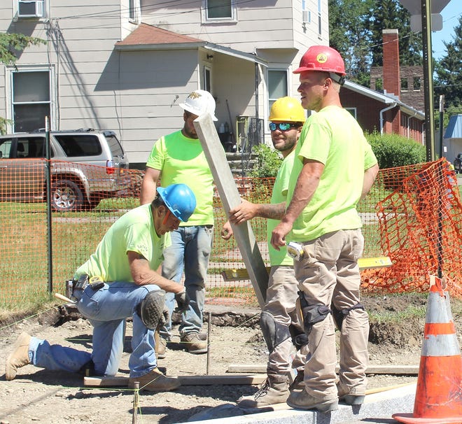 Crews are shown working on curb rams in Corning last week. [JANA AIKEN/THE LEADER]