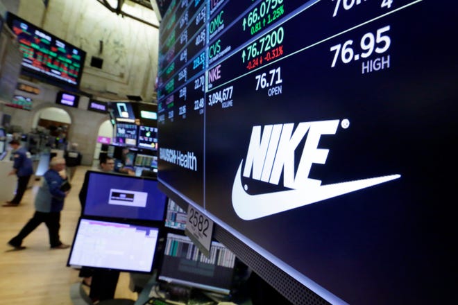 The logo for Nike is displayed above a trading post on the floor of the New York Stock Exchange on Monday. U.S. stock indexes capped a day of listless trading with a mixed finish as gains by banks and technology companies were offset by losses in other sectors. [AP Photo / Richard Drew]