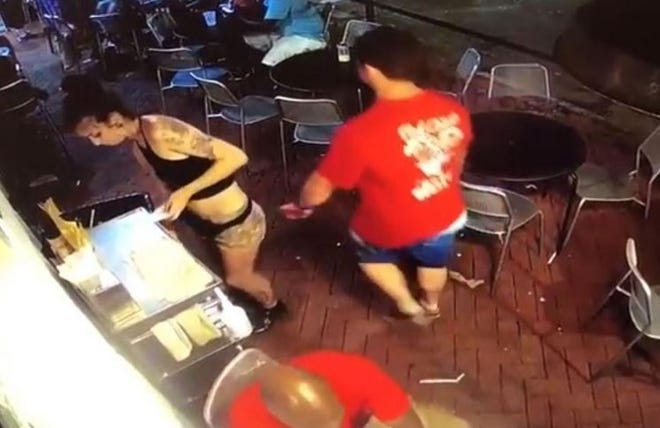 This screenshot from a video posted on reddit.com shows Ryan Cherwinski, 31, of Palm Bay, Florida, walking past a female server at Vinnie Van Go-Go's while reaching out with his left hand to grope her on June 30. [Courtesy reddit.com]
