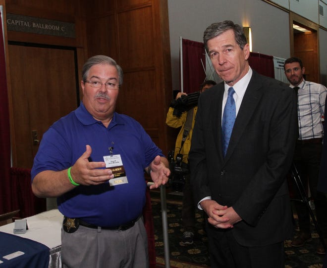 Craven County Sheriff Jerry Monette welcomes Gov. Roy Cooper to the North Carolina Sheriffsí Association 96th annual Training Conference at the New Bern Riverfront Convention Center, July 24, 2018. [Gray Whitley / Sun Journal Staff]