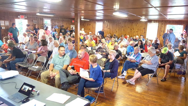 About 100 people packed the Kendig Park meeting house in Hayesville on Tuesday night for a community meeting to show support for a $500,000 revitalization grant to enhance the quality of life in the village and for an update on options to upgrade the village water system.
