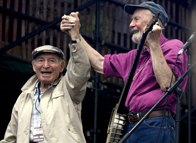 With help of performers like Pete Seeger, right, George Wein founded the Newport Folk Festival in 1959. The two are shown during the 50th anniversary of the event at Fort Adams State Park. [ASSOCIATED PRESS FILE PHOTO]