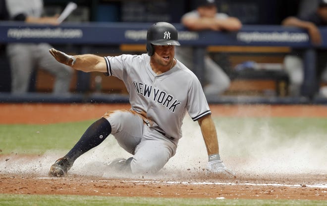 New York Yankees' Brett Gardner slides in to score on a sacrifice fly by Giancarlo Stanton during the eighth inning on Wednesday. The Rays won 3-2. [AP PHOTO/MIKE CARLSON]
