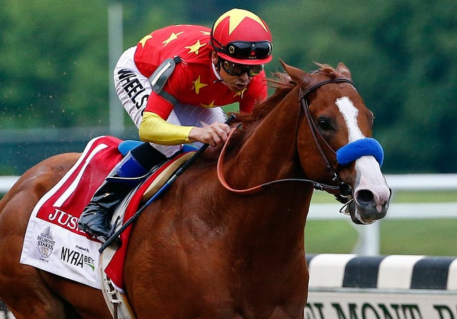 Justify, with jockey Mike Smith up, wins the Belmont Stakes and the Triple Crown on June 9. [Peter Morgan/The Associated Press]