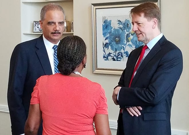 Former U.S. Attorney General Eric Holder (left) and Democratic gubernatorial candidate Richard Cordray talk with a panelist  ahead of a roundtable on criminal justice reform in Columbus on Thursday. (Randy Ludlow/Dispatch)