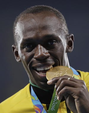 Jamaica's Usain Bolt poses with a gold medal at the 2016 Summer Olympics in Rio de Janeiro. [Jae C. Hong/The Associated Press]