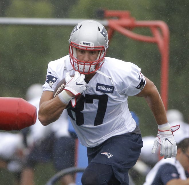 Patriots tight end Rob Gronkowski performs an agility drill during the first practice of training camp on Thursday. Gronkowski caught a touchdown pass the first time he was targeted during 11-on-11 action. [AP Photo/Steven Senne]